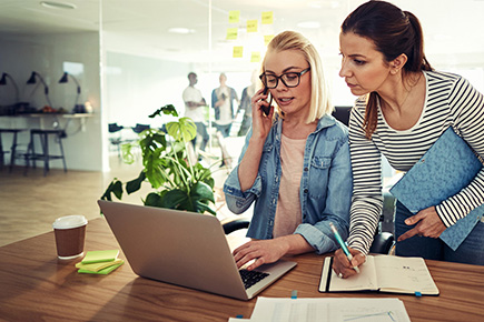 Two people discussing a task at work.