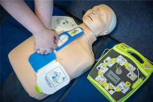 A person using a training defibrillator.