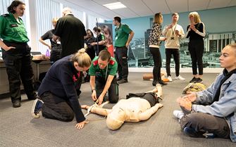 A group of people learning in a first aid class. A group of people learning in a first aid class.